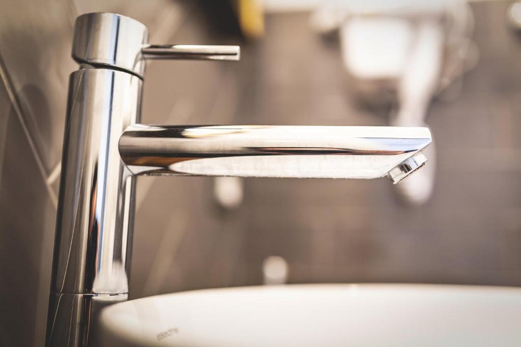 a close up of a faucet of a sink at Piazza Duomo Deluxe in Cecina