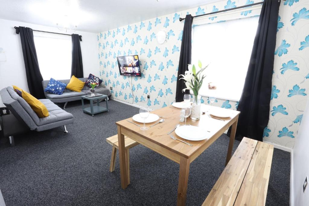 a living room with a table and a couch at B'ham NEC/Airport/HS2 Short Stay in Birmingham
