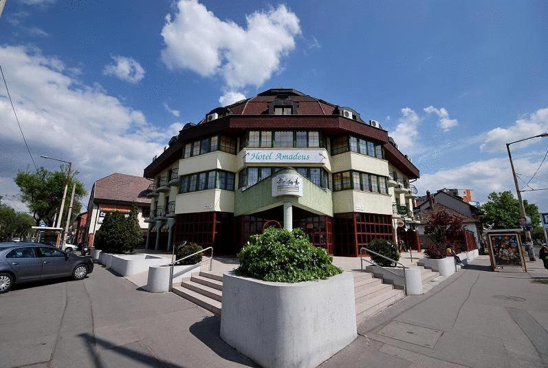 a building with a car parked in front of it at Hotel Amadeus in Budapest