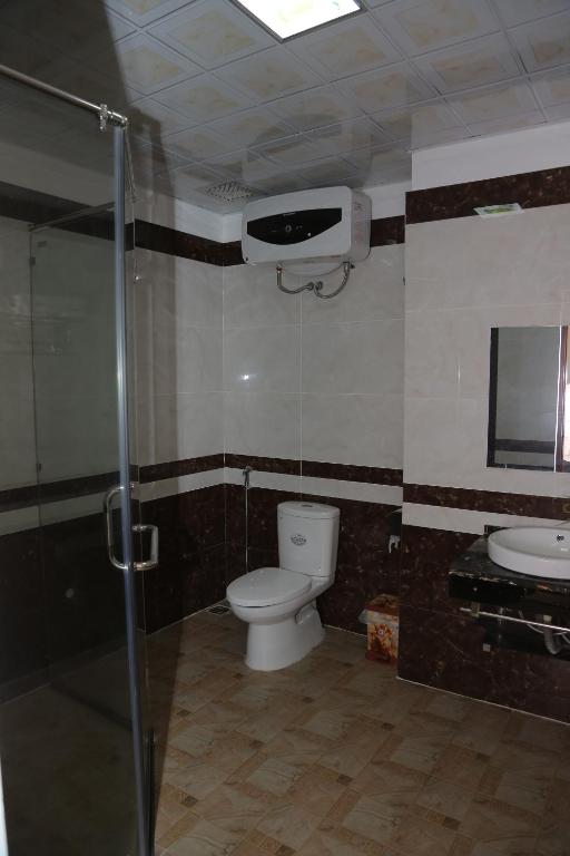 a bathroom with a toilet and a shower and a sink at Mai Anh Hotel in Lao Cai