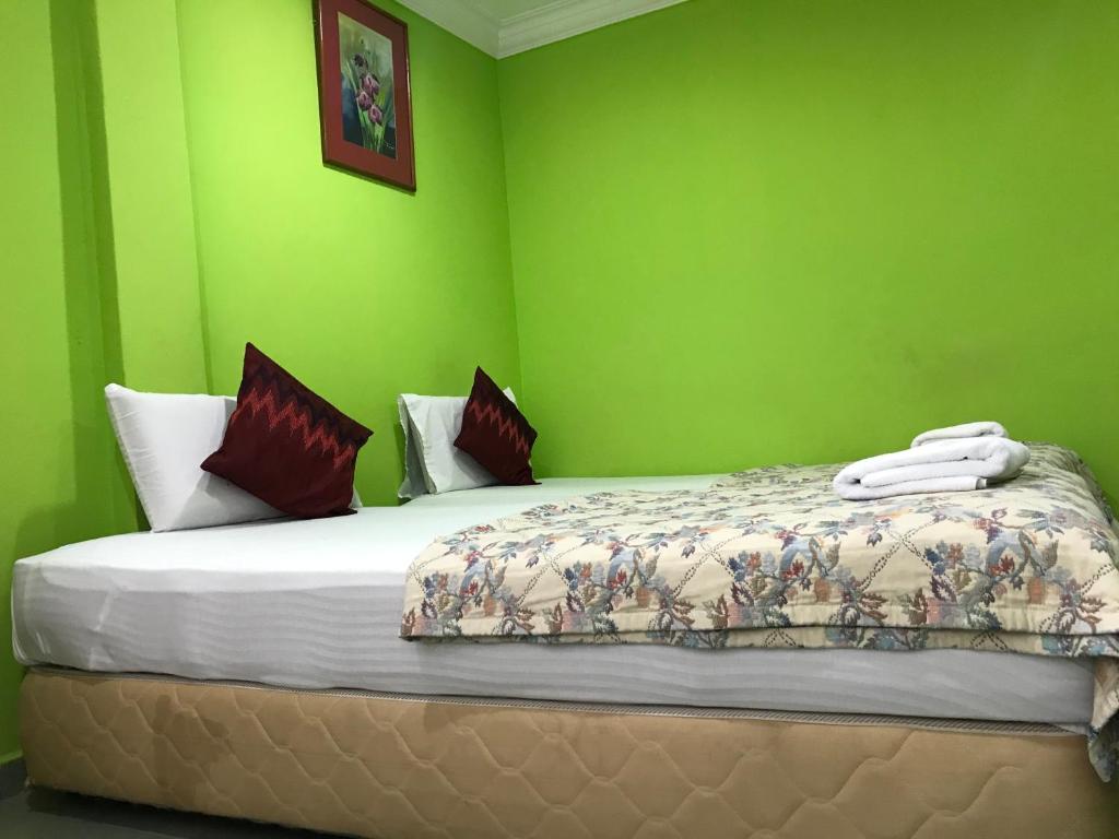 Postel nebo postele na pokoji v ubytování Hotel Cahaya