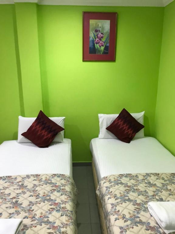 Postel nebo postele na pokoji v ubytování Hotel Cahaya