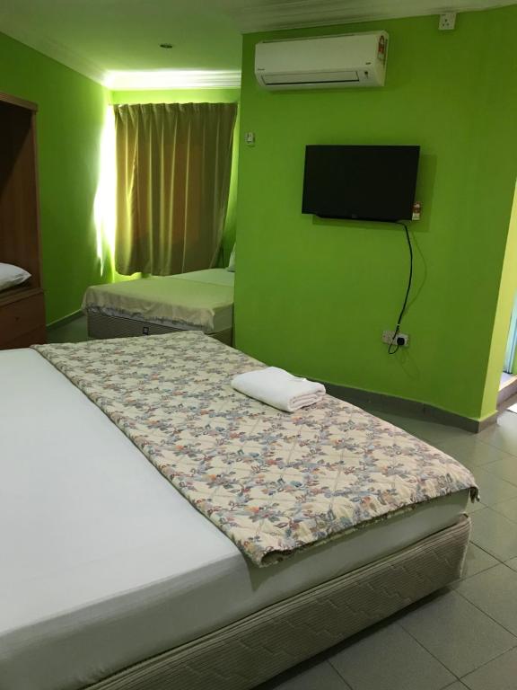 Postel nebo postele na pokoji v ubytování Hotel Cahaya