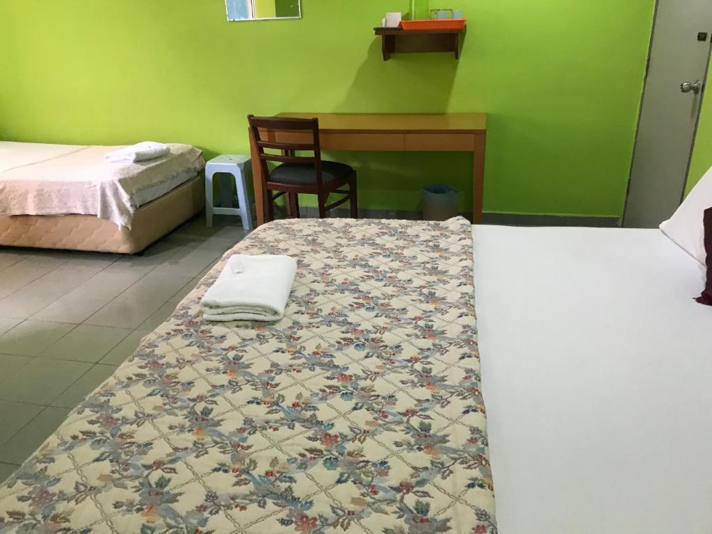 Postel nebo postele na pokoji v ubytování Hotel Cahaya