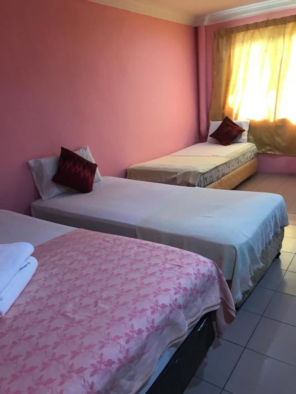 Postel nebo postele na pokoji v ubytování Hotel Cahaya