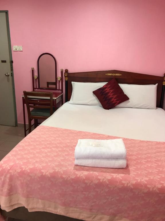 Postel nebo postele na pokoji v ubytování Hotel Cahaya