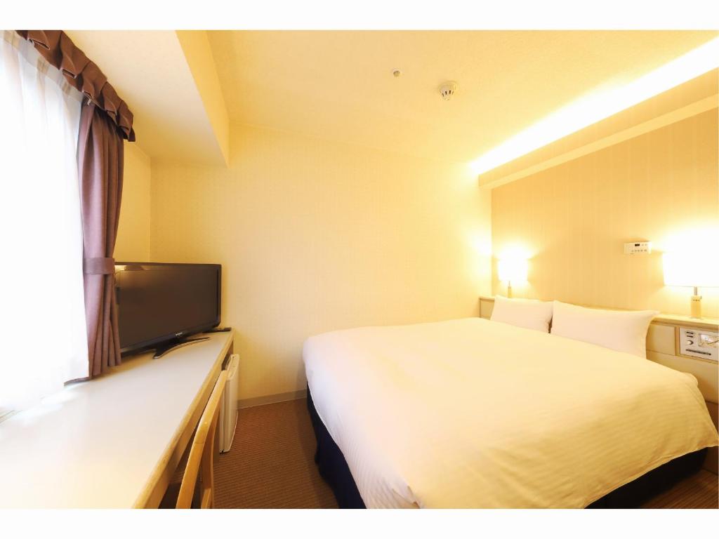Postel nebo postele na pokoji v ubytování Shin-Yokohama Kokusai Hotel