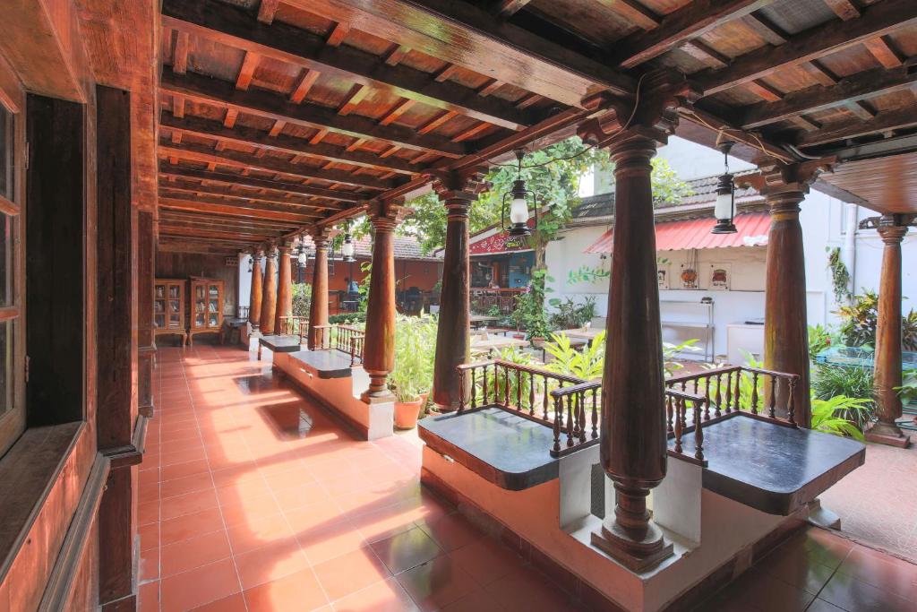 a porch of a building with benches on it at Rossitta Wood Castle in Cochin