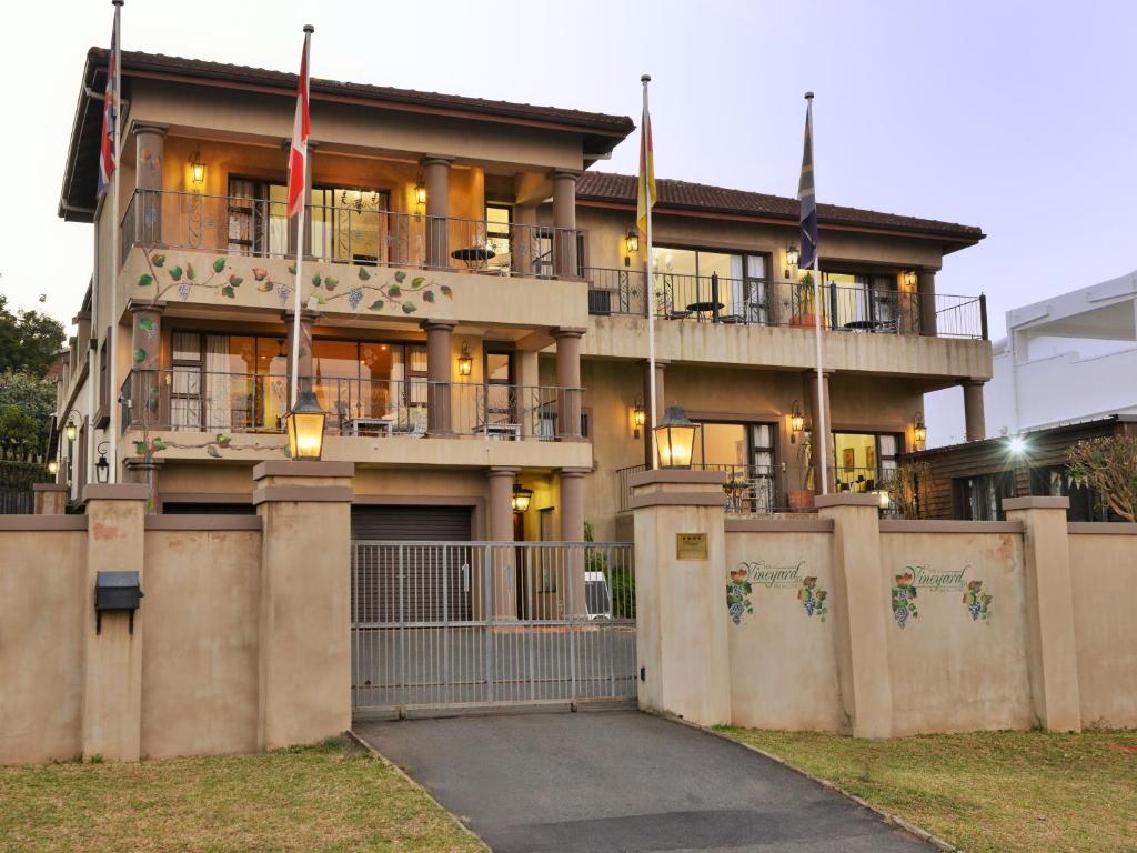 a large building with a flag on top of it at The Vineyard on Ballito in Ballito