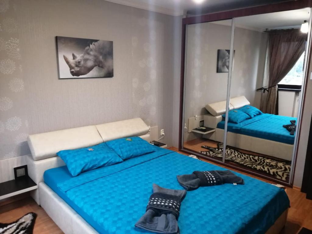 a bedroom with two beds and a mirror at CoquetteHouse Parc Gara de Nord in Bucharest
