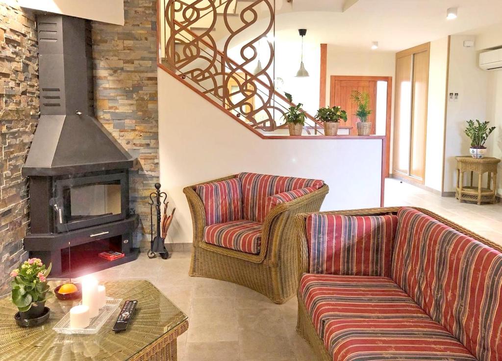 a living room with two couches and a fireplace at 4 bedrooms house with terrace and wifi at Cretas in Cretas