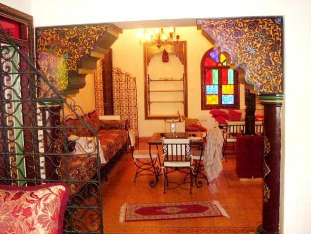 a living room with a staircase and a living room with at Résidence Miramare Marrakech in Marrakesh