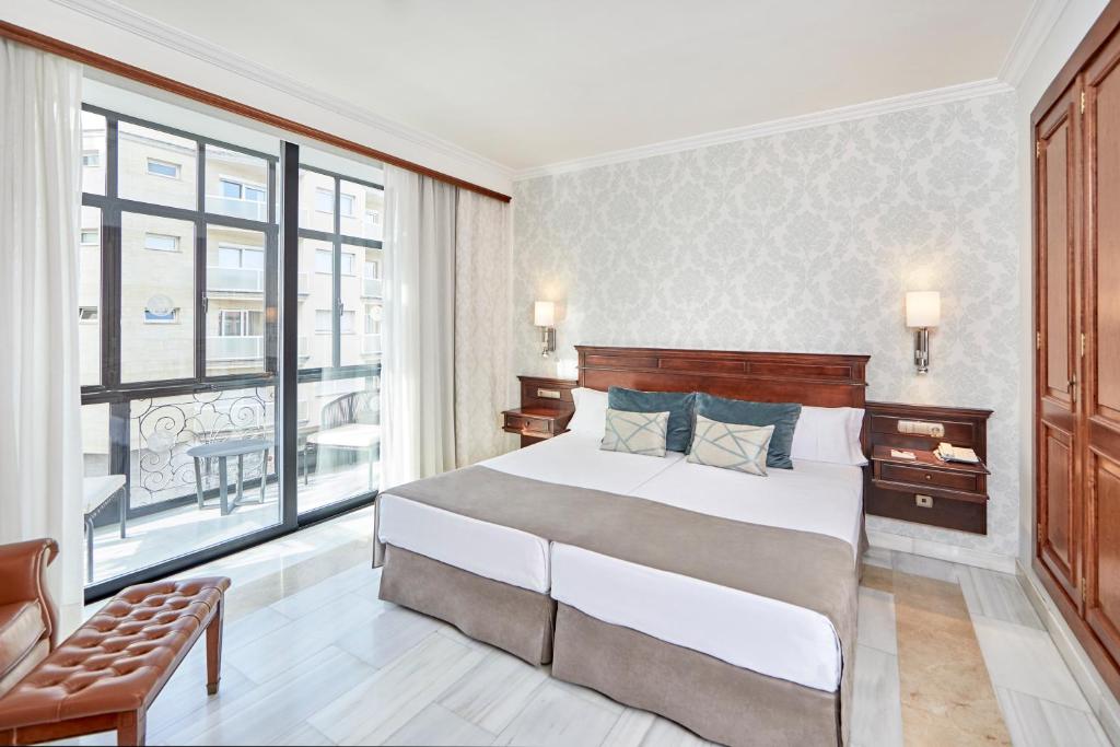 a bedroom with a large bed and a large window at Bordoy Continental Palma in Palma de Mallorca