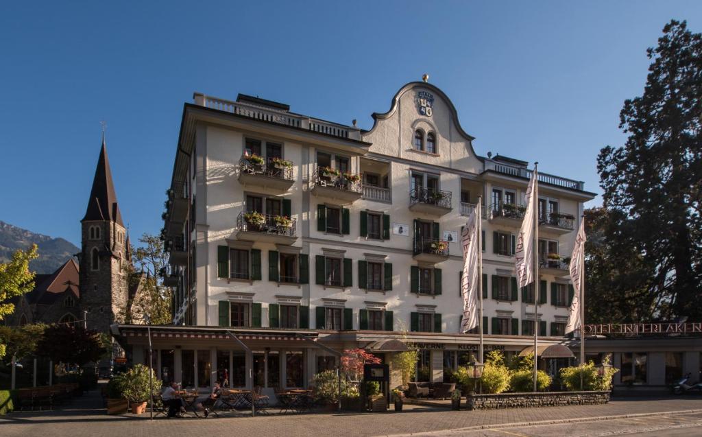 
a large building with a clock on the front of it at Hotel Interlaken in Interlaken
