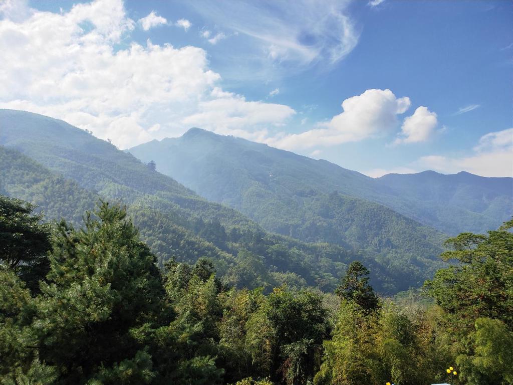 a view of a mountain range with trees and mountains at Kingtaiwan Hotel in Lugu Lake