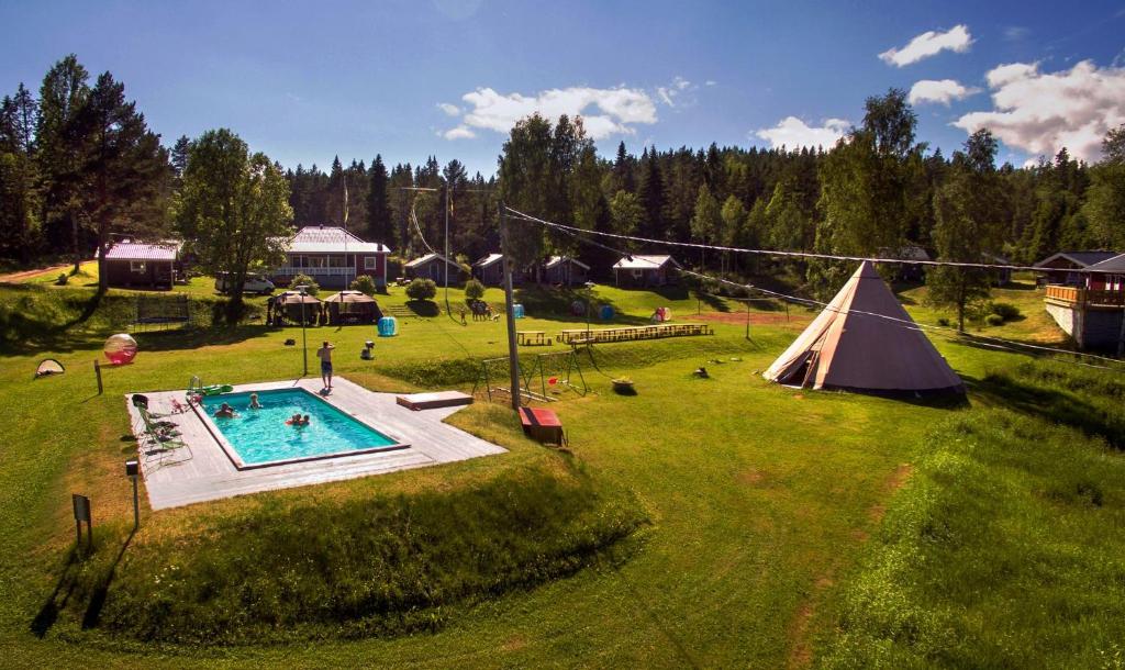 an aerial view of a backyard with a tent and a pool at Ulvö Lakeside Resort in Ulvöhamn