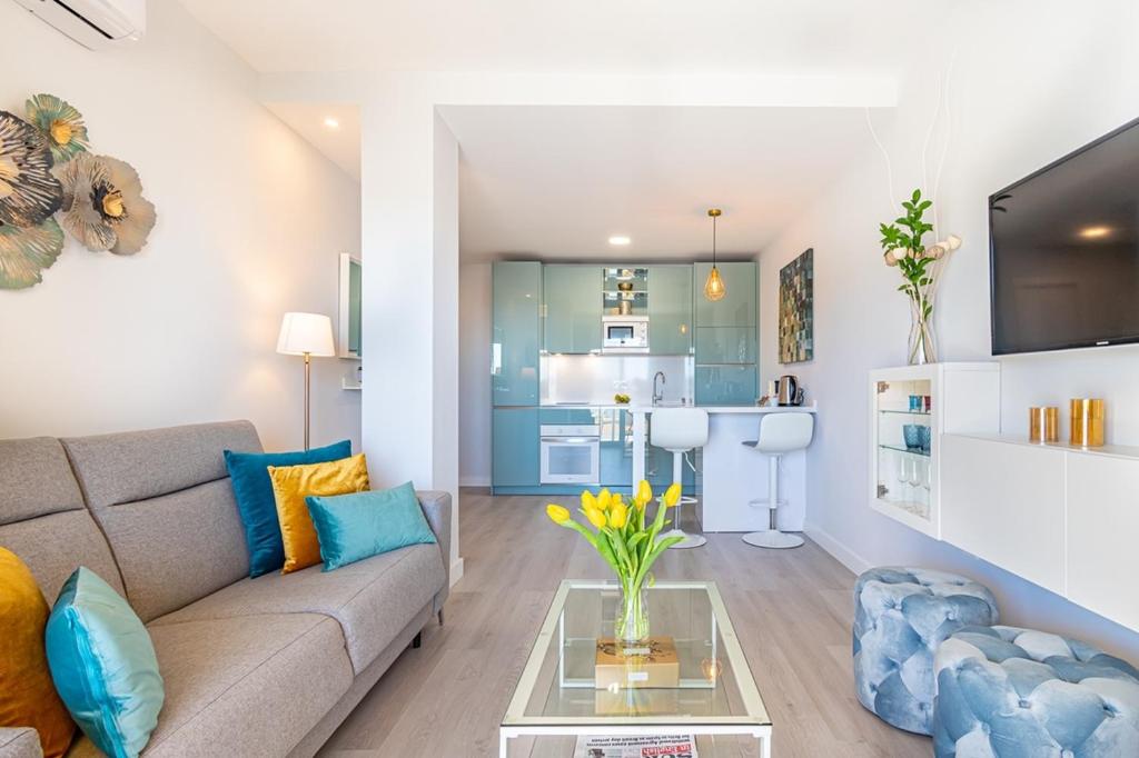 a living room with a couch and a table at Divina Home Apartments in La Cala de Mijas