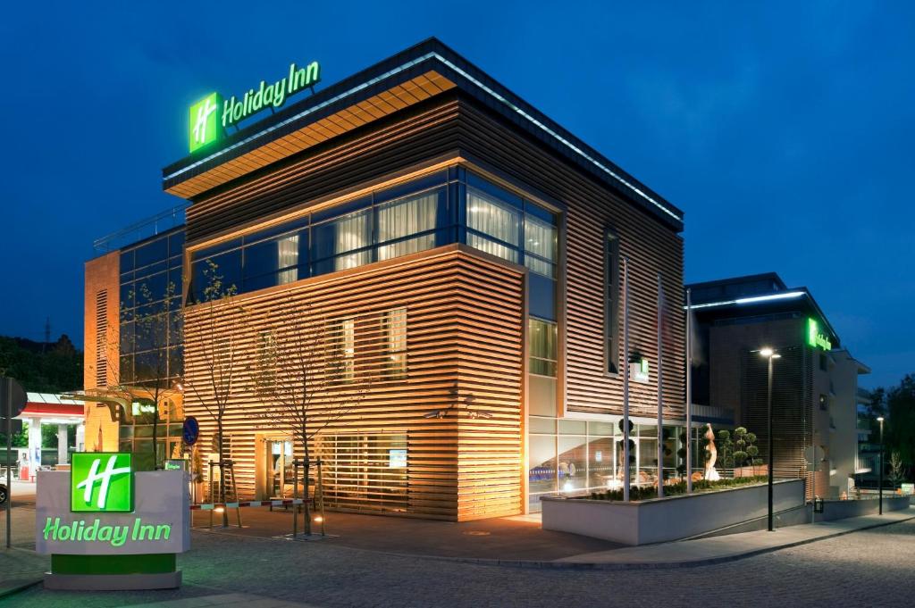 a building with a sign on the side of it at Holiday Inn Bydgoszcz, an IHG Hotel in Bydgoszcz