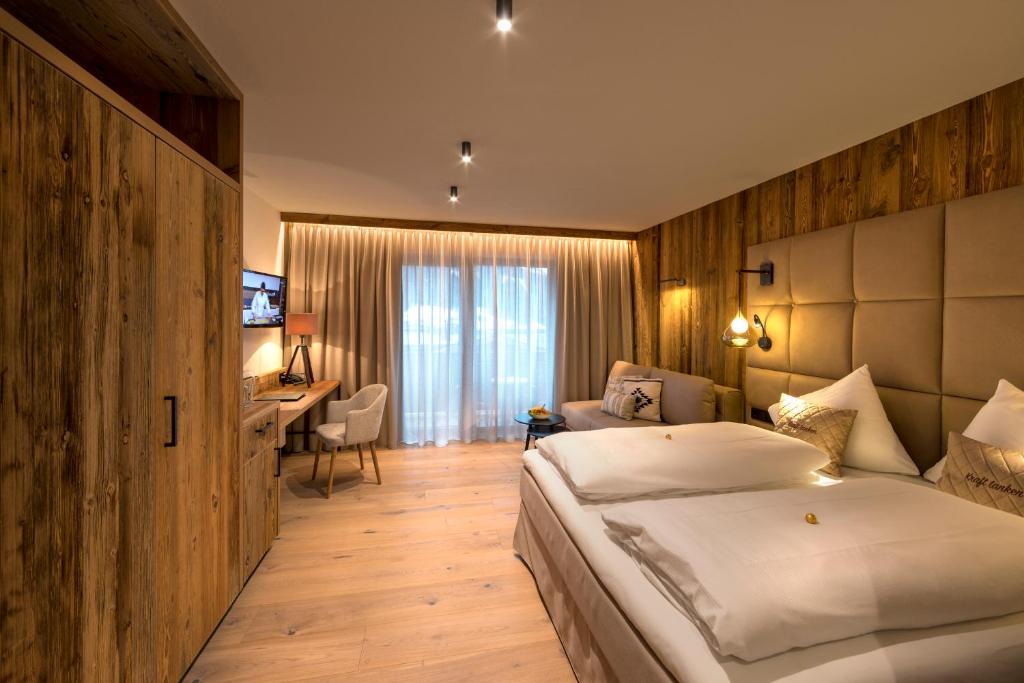 Postel nebo postele na pokoji v ubytování Aktivhotel Alpendorf