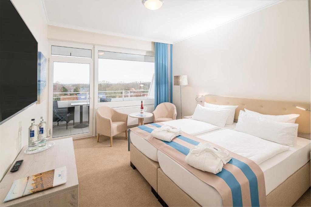 Postel nebo postele na pokoji v ubytování Hotel Bellevue