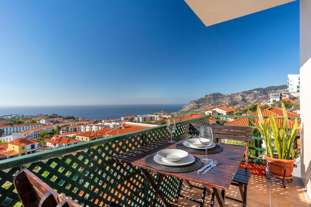 a table on a balcony with a view of the ocean at Barcelos Apartment by HR Madeira in Funchal