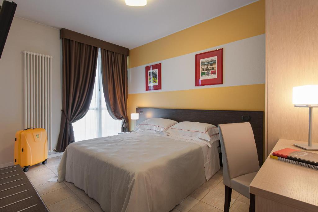 Postel nebo postele na pokoji v ubytování Hotel Maranello Village