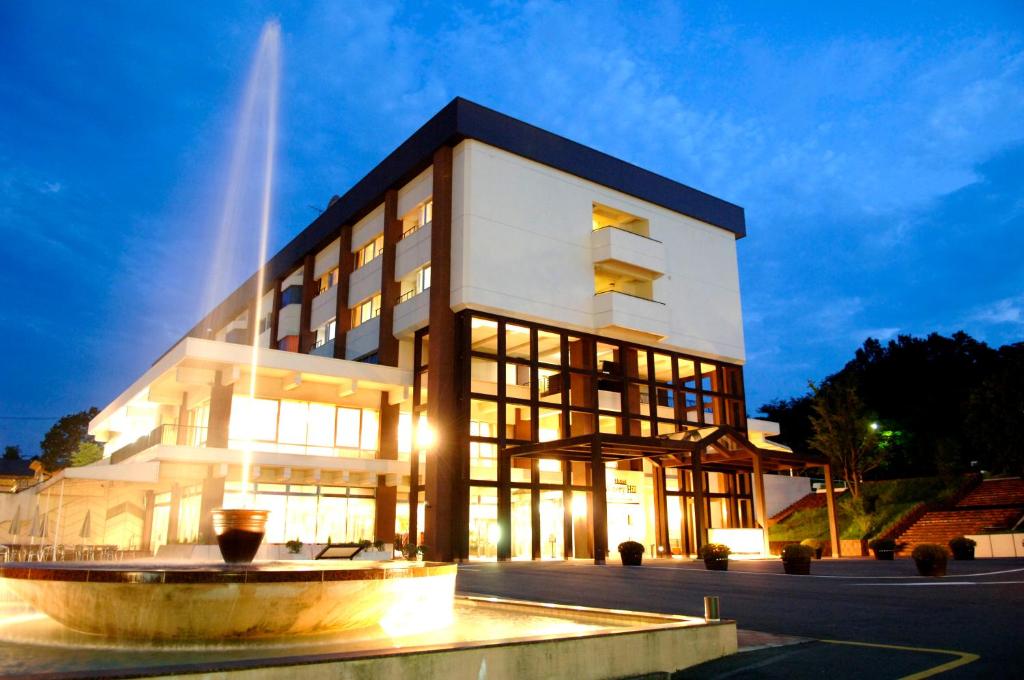 a building with a fountain in front of it at Hotel Winery Hill in Izu