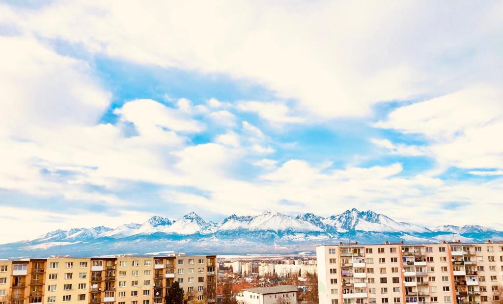 a view of a city with mountains in the background at Apartment HIGH TATRAS in Poprad