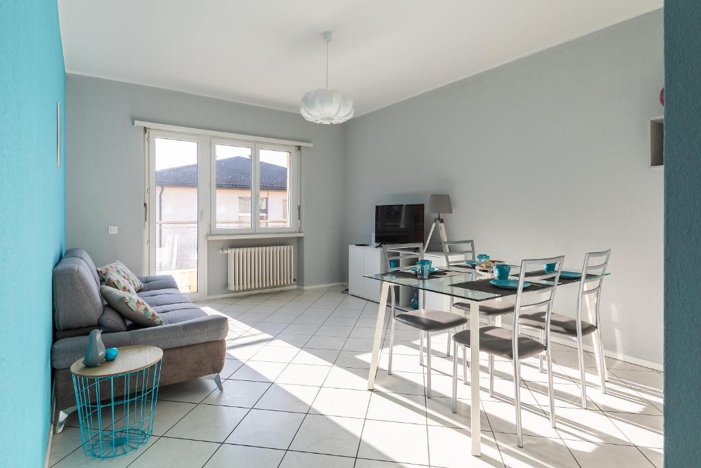 a living room with a couch and a table at Lido Apartments by Quokka 360 - 5 min from the centre and the Lugano Lido in Lugano