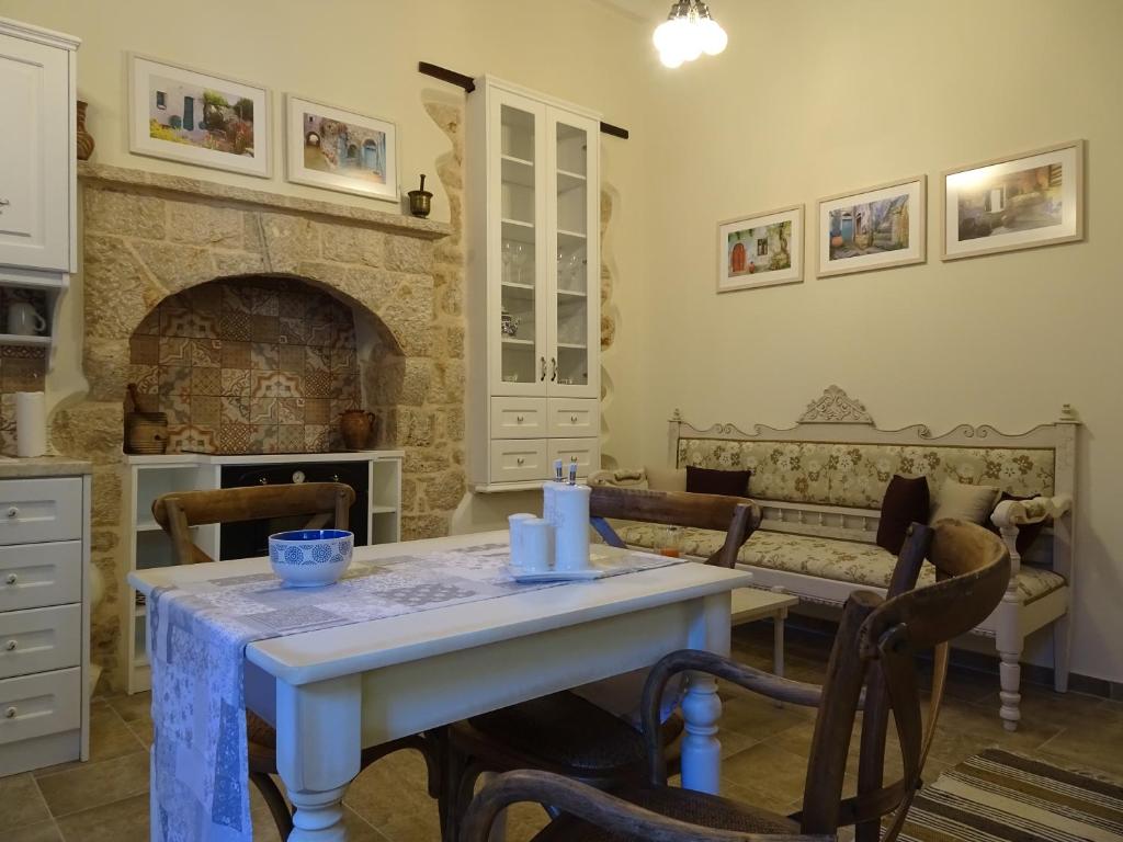 a dining room with a table and a fireplace at Muse Mese in Halki