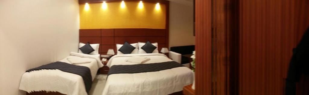 Postel nebo postele na pokoji v ubytování HOTEL SPARK RESIDENCY