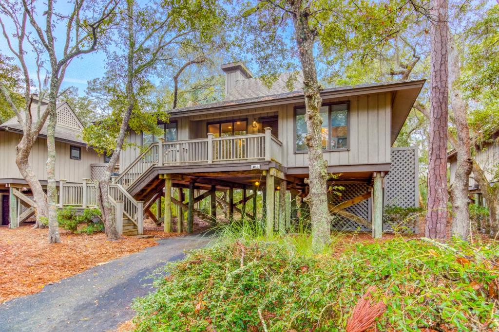 a home with a large deck in the woods at Night Heron 4117 in Kiawah Island