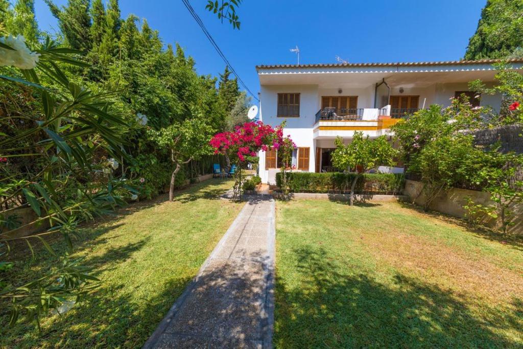 a house with a garden in front of it at Bouganvillea in Port de Soller