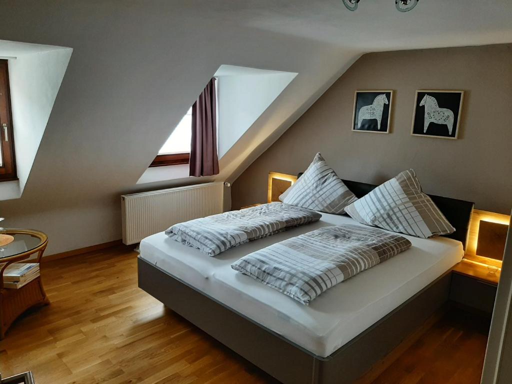 a bedroom with a large bed in a attic at Ferienhaus Elisa in Trittenheim