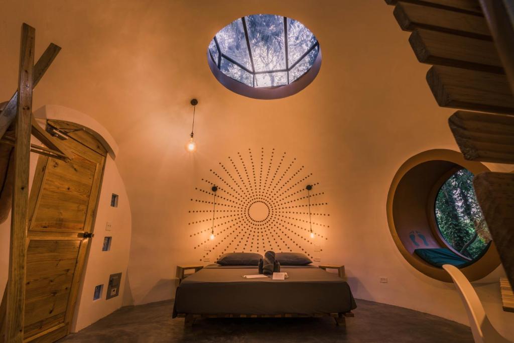 a bedroom with a bed and two large windows at Nowhere in Bocas del Toro
