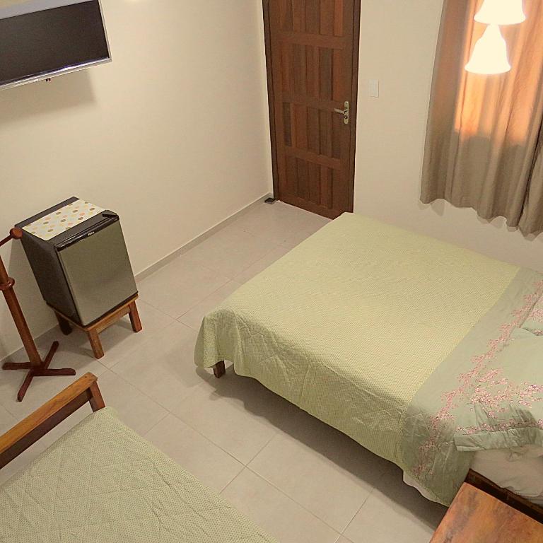Postel nebo postele na pokoji v ubytování Recanto Abayomi