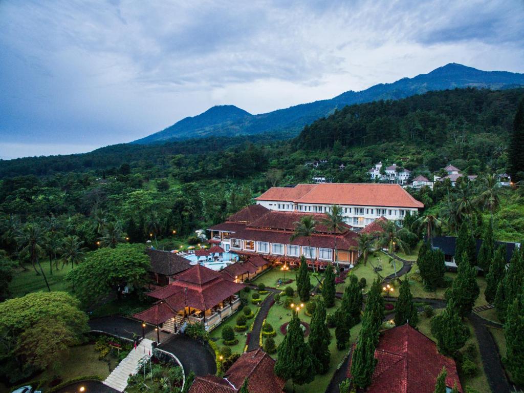 an aerial view of a resort with mountains in the background at Royal Trawas Hotel & Cottages in Trawas