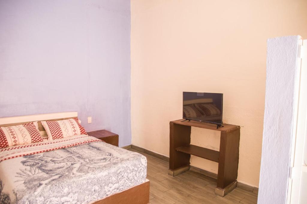 Postel nebo postele na pokoji v ubytování Hotel Cuauhtemoc