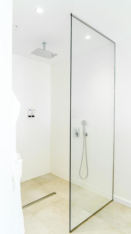 a mirror in a bathroom with a shower at CalaLanzarote Suites Hotel - Adults Only in Playa Blanca