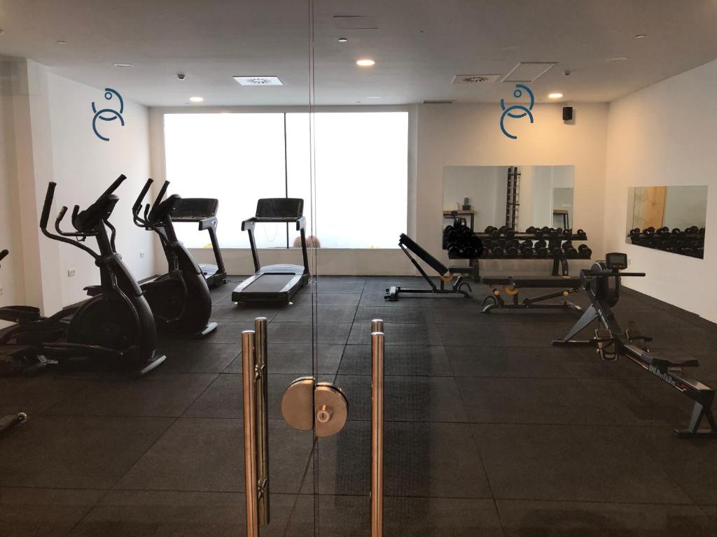 a gym with treadmills and exercise bikes in a room at CalaLanzarote Suites Hotel - Adults Only in Playa Blanca