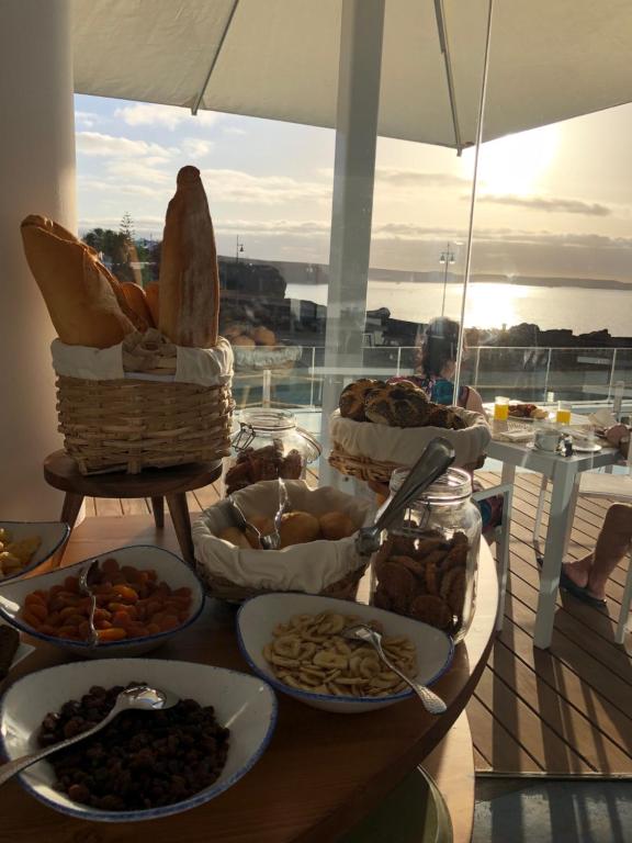 a table with bread and other food on a boat at CalaLanzarote Suites Hotel - Adults Only in Playa Blanca