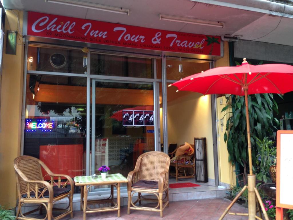 a red umbrella sitting in front of a restaurant at Just Chill Inn in Chiang Mai