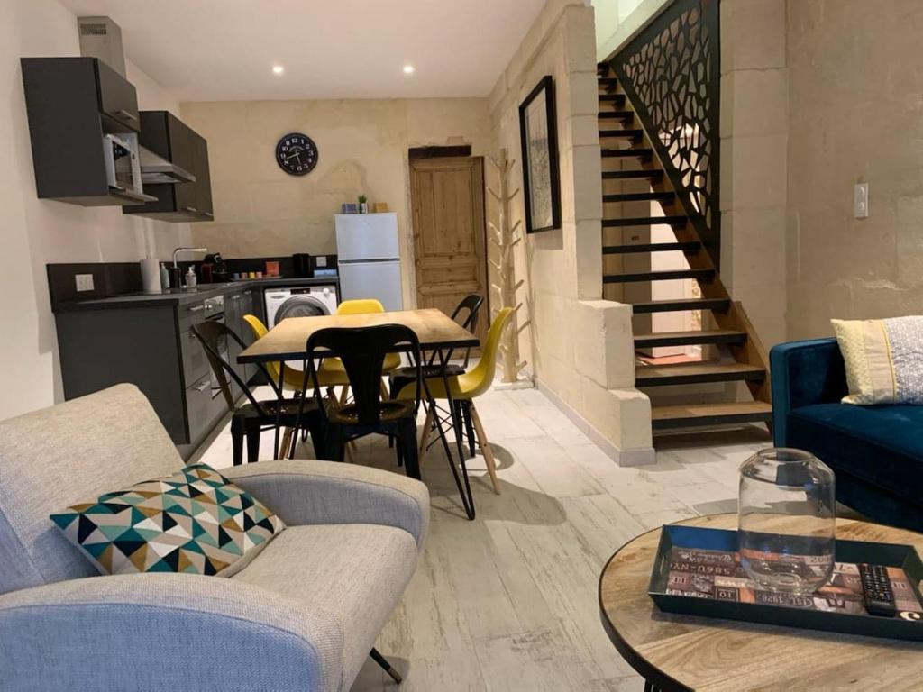 a living room with a blue couch and a table at Le refuge des arènes in Arles