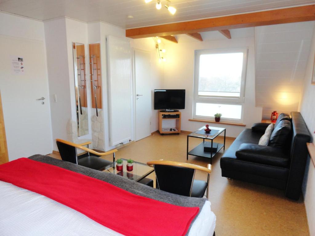 uma sala de estar com uma cama e um sofá em Appartement Pension Schüßler em Waldeck
