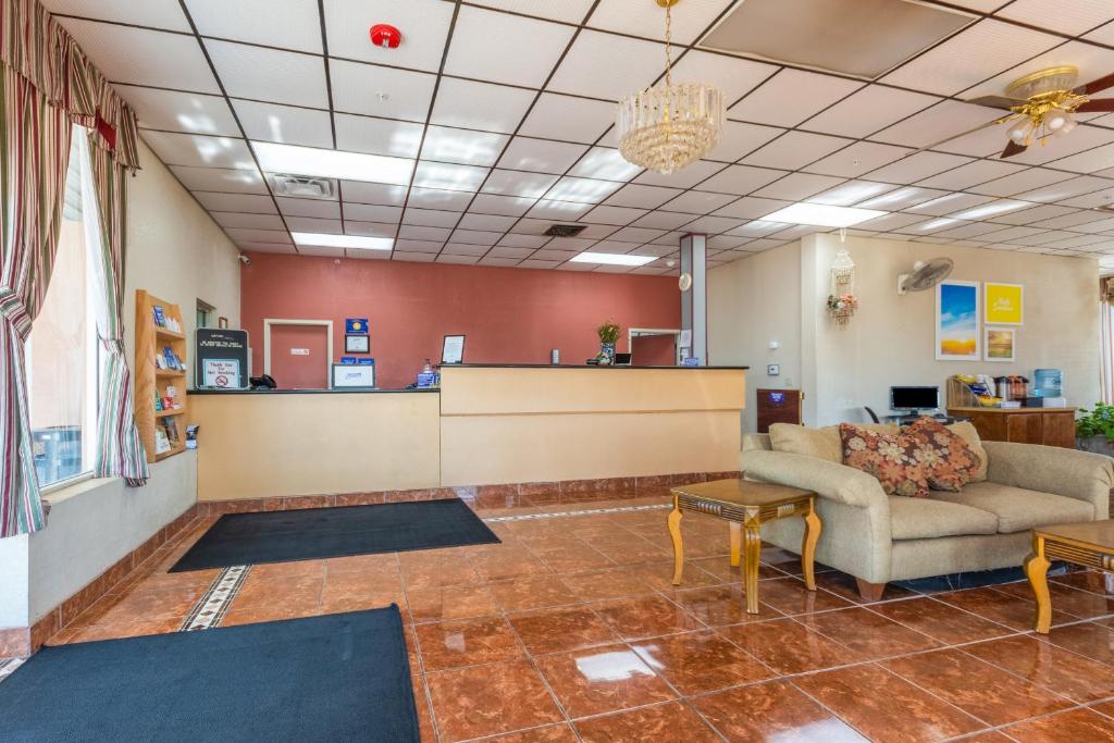 a lobby of a waiting room with a couch and tables at Americas Best Value Inn of Elk City in Elk City