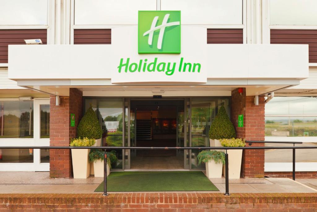 a hotel entrance with a holiday inn sign at Holiday Inn Chester South, an IHG Hotel in Chester