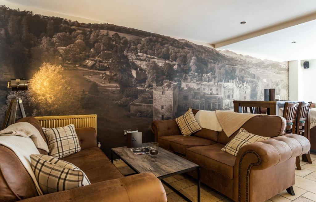a living room with couches and a wall mural at The Pennington Hotel in Ravenglass