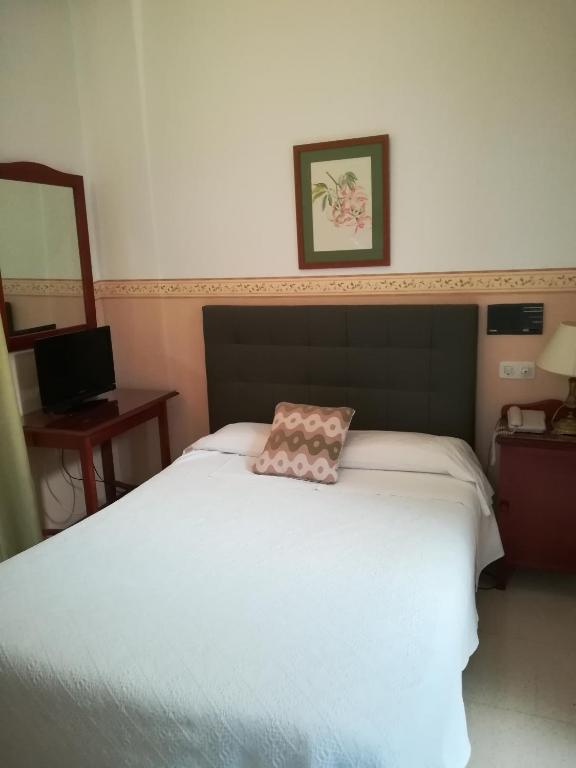 Postel nebo postele na pokoji v ubytování Nuevo Hotel