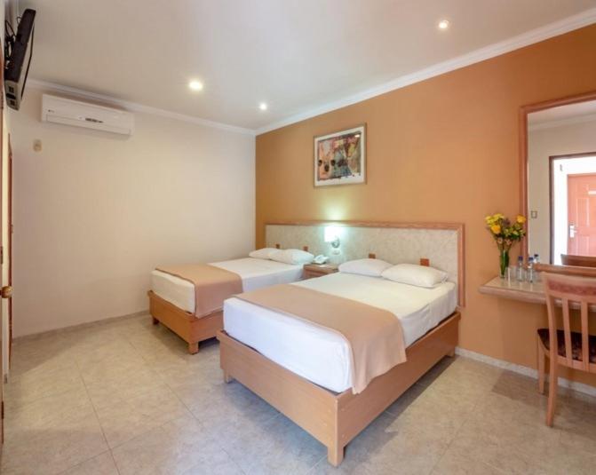 Postel nebo postele na pokoji v ubytování Tecnohotel Itzáes