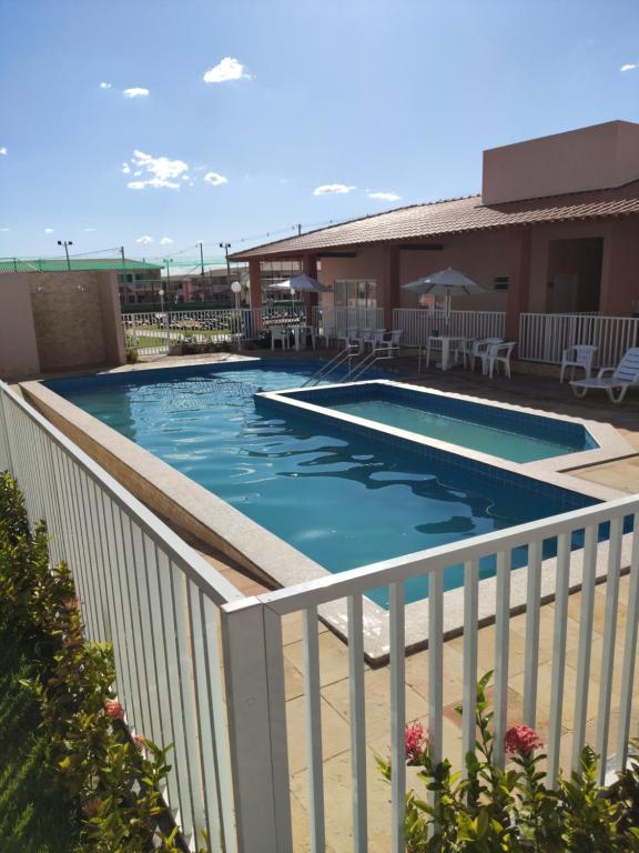 a swimming pool with a white fence around it at Apartamento Mobiliado em Petrolina - Recomendado! in Petrolina